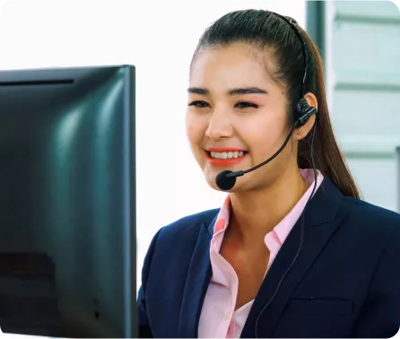 Customer support agent wearing a headset working at a computer
