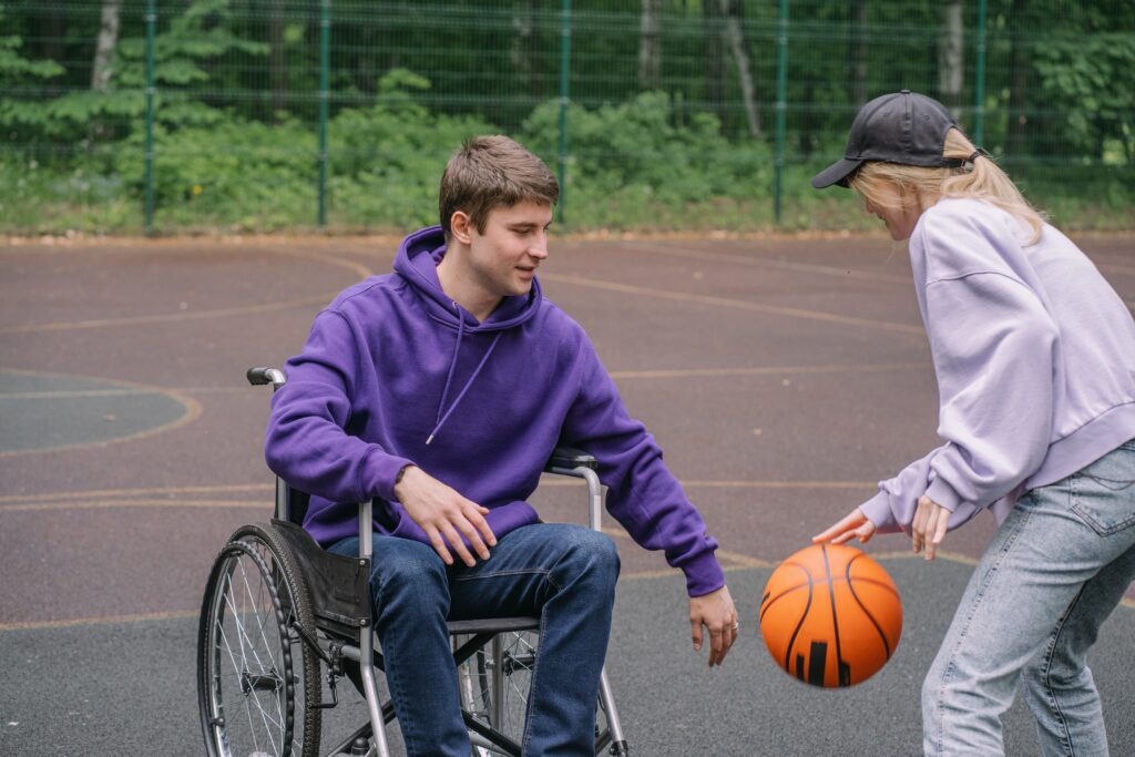 Two people play basketball
