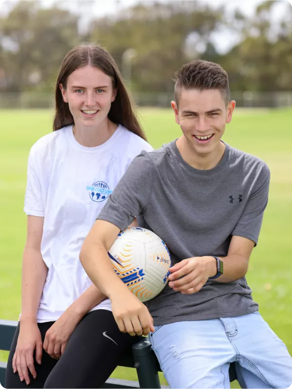 a man and a woman holding a football ball