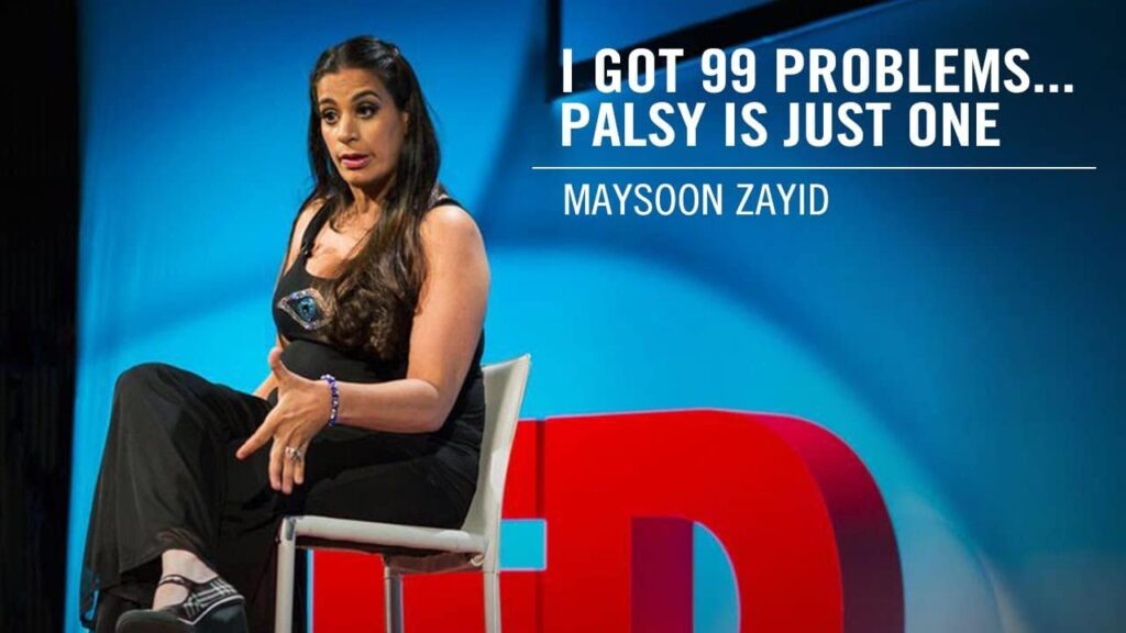Image is a woman (Maysoon Zayid) sitting on a chair talking to the audience at her Ted Talk.