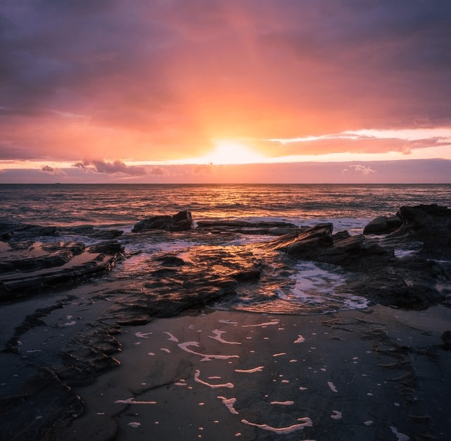 The sun setting over the ocean