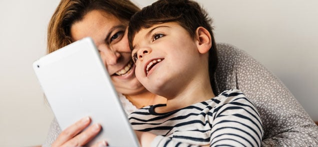 Mother and son play with tablet device together