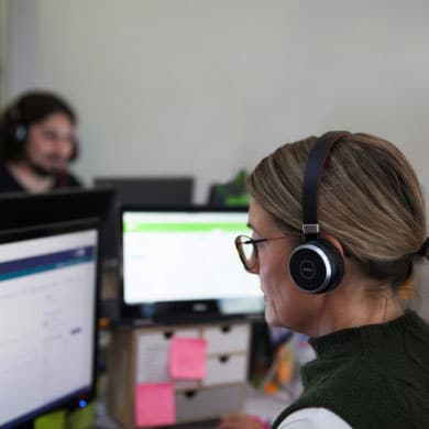 A woman with a headset working in an office