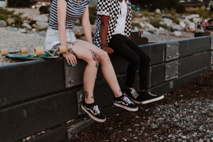 Two friends sitting on a wall