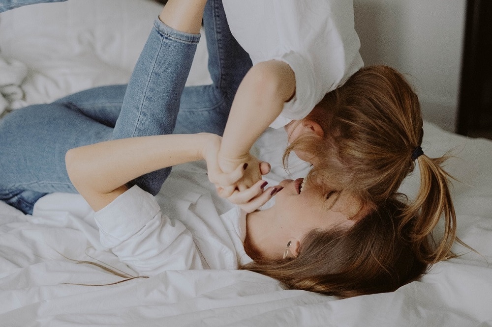 A mum and daughter playing and laughing