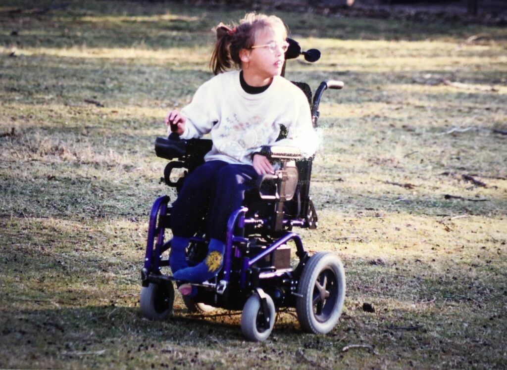 A photo of our guest blogger Gretta in a wheelchair when she was growing up. 