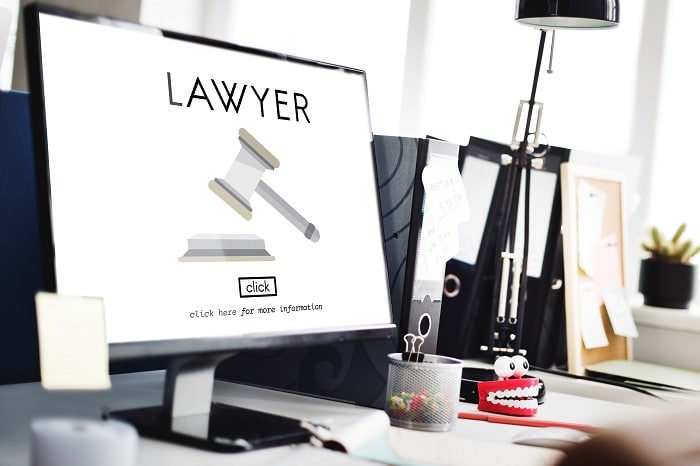 A desktop computer with the word 'lawyer' on the screen