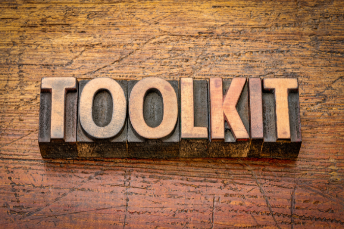 The word 'TOOLKIT' in wooden letters.