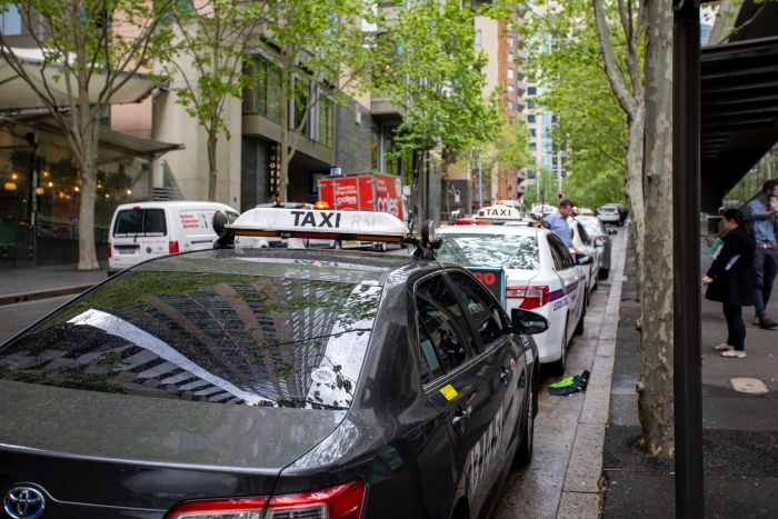 A line of taxis in the city.