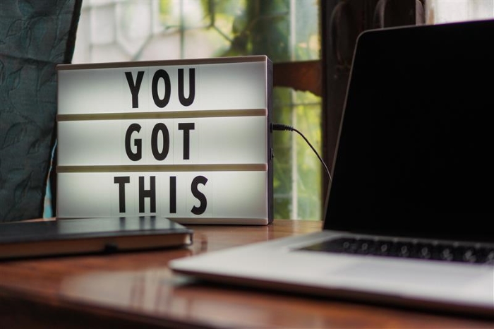 A sign on a desk says 'you got this'