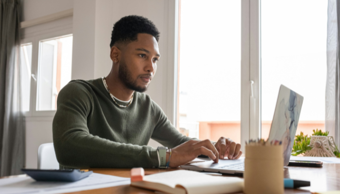 A person sitting in front of a laptop.