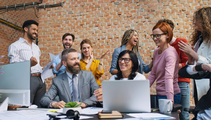 A group of happy people in an office setting.